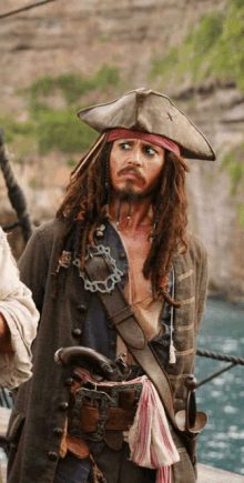 a man dressed as a pirate with dreadlocks and a hat with a x on it