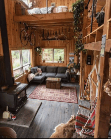 a living room with a couch and a hammock and a bicycle hanging from the ceiling