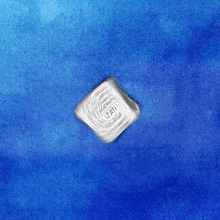 a silver square with the letters ati on a blue background