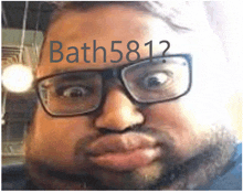 a man with glasses and a beard has bath581 written on his forehead