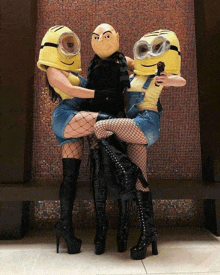 two women in minion costumes pose for a photo