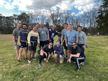 a group of men are posing for a picture with one wearing a jersey that says virginia tech