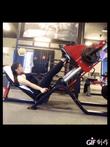 a woman is doing leg press exercises in a gym with a sign that says ' boxing ' on it