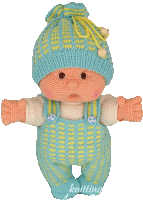 a knitted baby doll wearing a blue hat