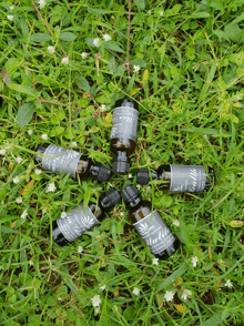 several bottles of essential oils are arranged in a circle on the grass