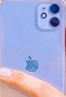 a close up of a person holding a blue iphone in a clear case .