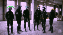 a group of soldiers are standing in a room with hearts on their faces and the words ne on their helmets