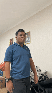 a man in a blue shirt stands in front of a box that says panasonic