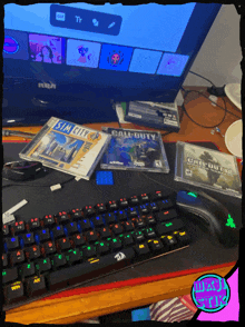 a keyboard sits on a desk next to a call of duty game and a sim city game