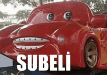 a red toy car with googly eyes and the word subeli on the bottom