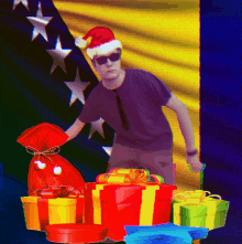 a man wearing a santa hat and sunglasses stands in front of a pile of gifts