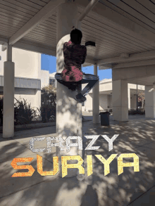 a picture of a person climbing a pillar with the words crazy suriya written on it