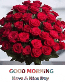 a bouquet of red roses with the words `` good morning have a nice day '' on it .