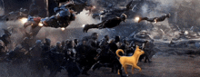 a yellow dog is standing in front of a group of people in a battle scene from avengers endgame .