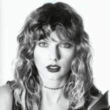 a woman with curly hair and a choker around her neck