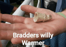 a person is holding a small object in their hand with the words bradders willy warmer written on the bottom