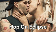 a couple of men kissing each other with the words `` hop on eclipse '' above them .