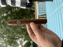 a person holding a cigar that says montecristo