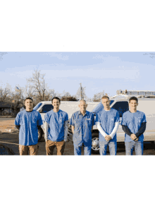 a group of men are posing for a picture in front of a van that says ' a & a ' on it