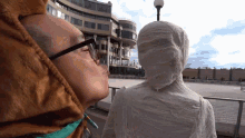 a man kissing a statue of a mummy in front of a building that says ' united states ' on it