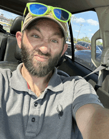 a man wearing sunglasses and a hat is taking a selfie