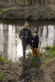 a man and a little boy are fishing in the water