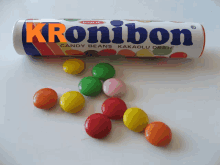 a tube of kronibon candy beans sits next to a pile of candy beans