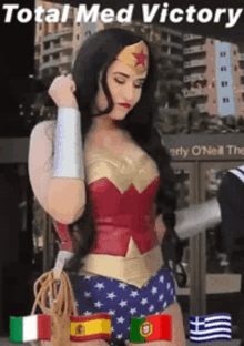 a woman in a wonder woman costume stands in front of a building