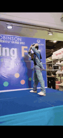 a person is standing on a stage in front of a robinson sign