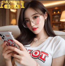 a woman wearing glasses and a hot shirt is looking at her cell phone