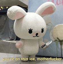 a stuffed bunny holding a knife with the words you 're on thin ice motherfucker below it