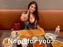 a woman sitting at a table with a plate of food and the words " none for you " below her