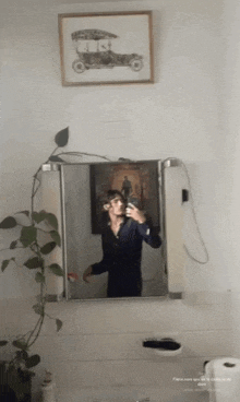 a man taking a picture of himself in a mirror