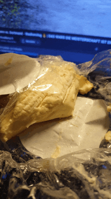 a piece of bread wrapped in plastic sits on a table