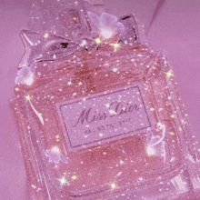 a bottle of miss dior perfume with a butterfly on it