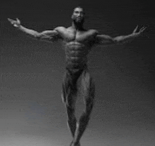 a black and white photo of a statue of a muscular man with his arms outstretched .