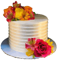 a white cake with pink and yellow flowers on top of it