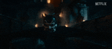 a person in a mask is flying through the air in a dark room .