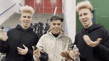 three young men standing next to each other with one holding a bottle of water that says ' water ' on it