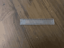 a clear plastic ruler on a wood table