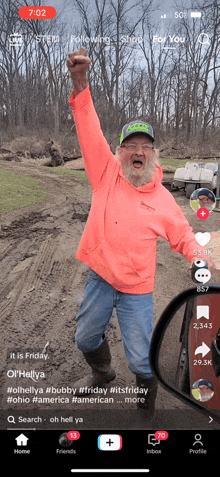 a man with a beard is holding his fist up in the air