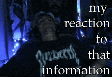 a man wearing a shirt that says " my reaction to that information " is laying down