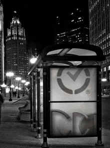 a black and white photo of a bus stop that says cc