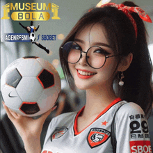 a woman wearing glasses holds a soccer ball in front of a museum bola ad