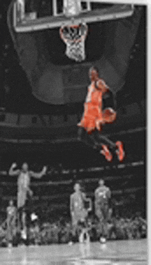 a black and white photo of a basketball player jumping in the air