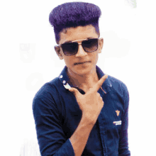 a young man wearing sunglasses and a blue shirt is making a peace sign