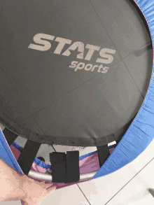 a person is holding a trampoline that says stats sports on it