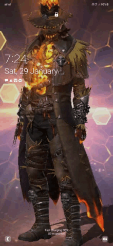 a phone screen shows a scarecrow with a fire coming out of his chest