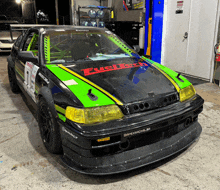 a green and black race car with fueltech on the hood