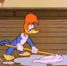 woody woodpecker is holding a mop and cleaning the floor .